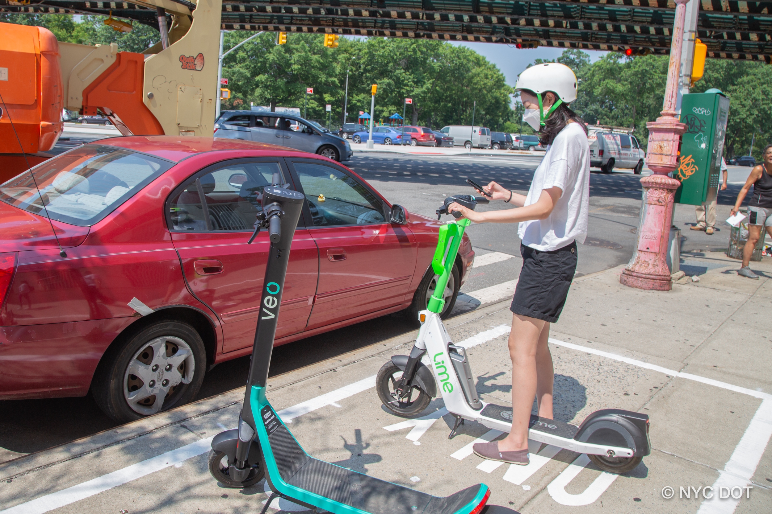 A person checking out an e-scooter